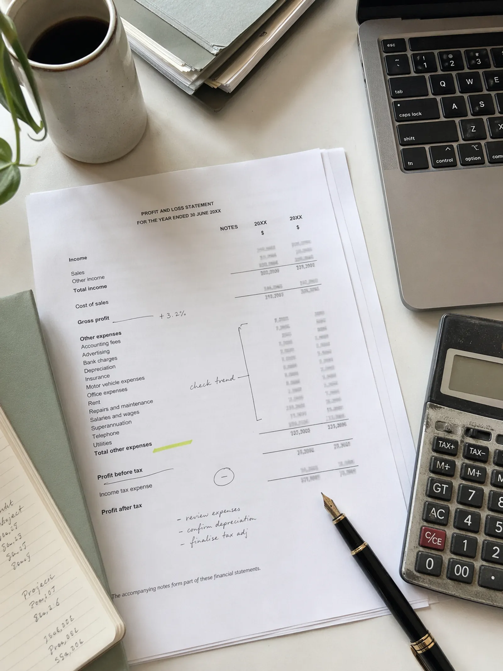 Accountant reviewing a profit and loss statement at their desk, representing professional indemnity insurance for accounting practices