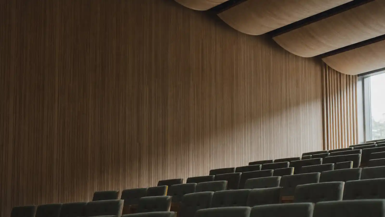 Auditorium with timber acoustic panelling, the design work covered by acoustic engineer professional indemnity insurance