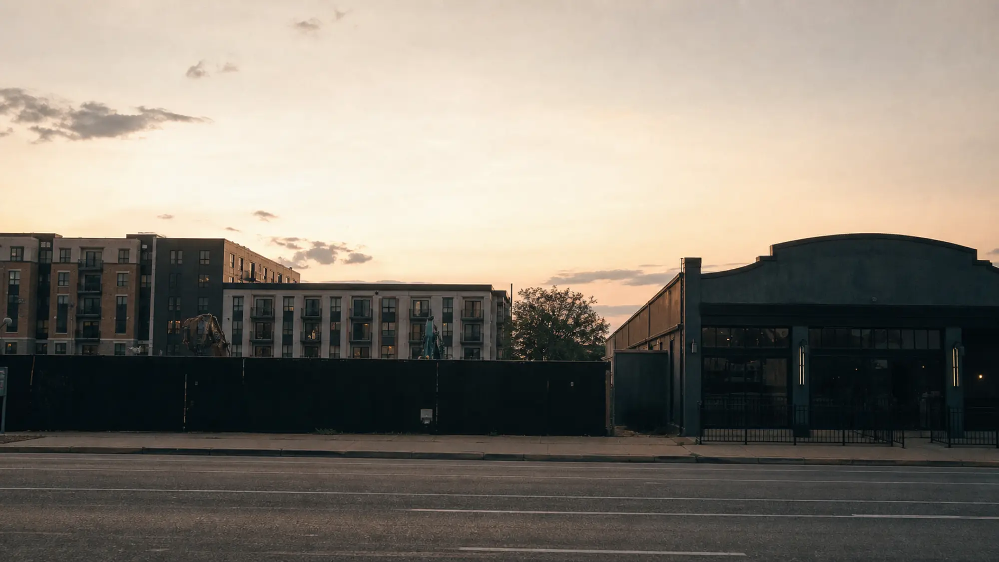 Venue and apartments sharing a street at dusk - noise assessment risk behind acoustic engineers insurance