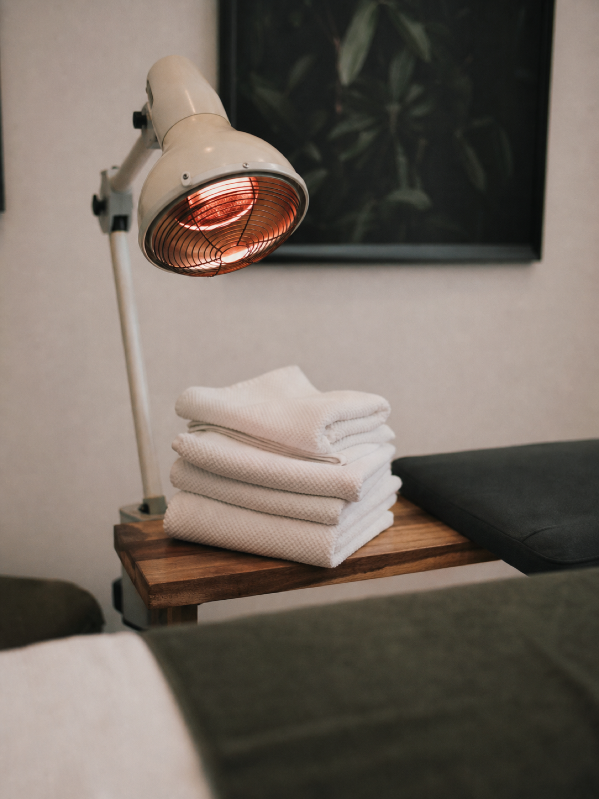 Folded towels and heat lamp in an acupuncture clinic, acupuncturist PI cover