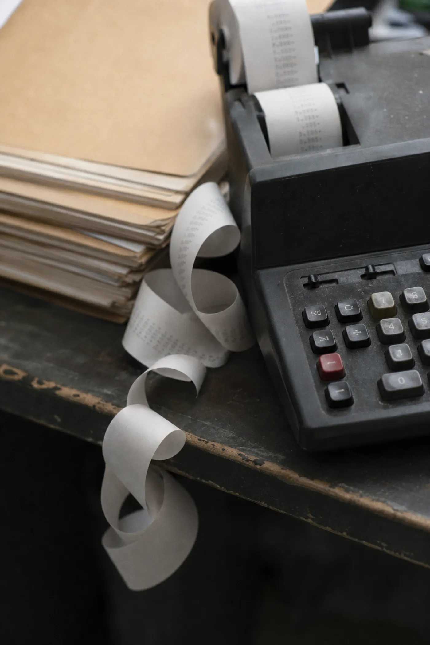 Adding machine with curled paper tape, professional indemnity cover for bookkeepers