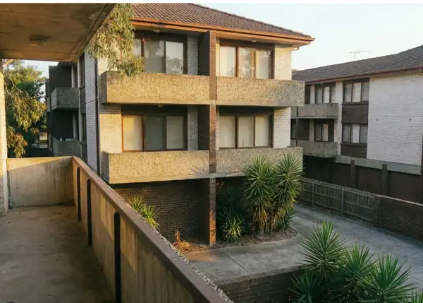 Close-up of building features including garages and balconies on a block of units, requiring accurate building sum insured.