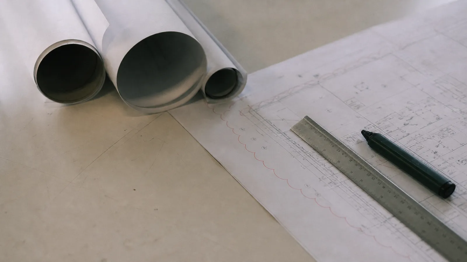 Rolled plan tubes and a plotted CAD drawing with scale rule, CAD operator professional indemnity
