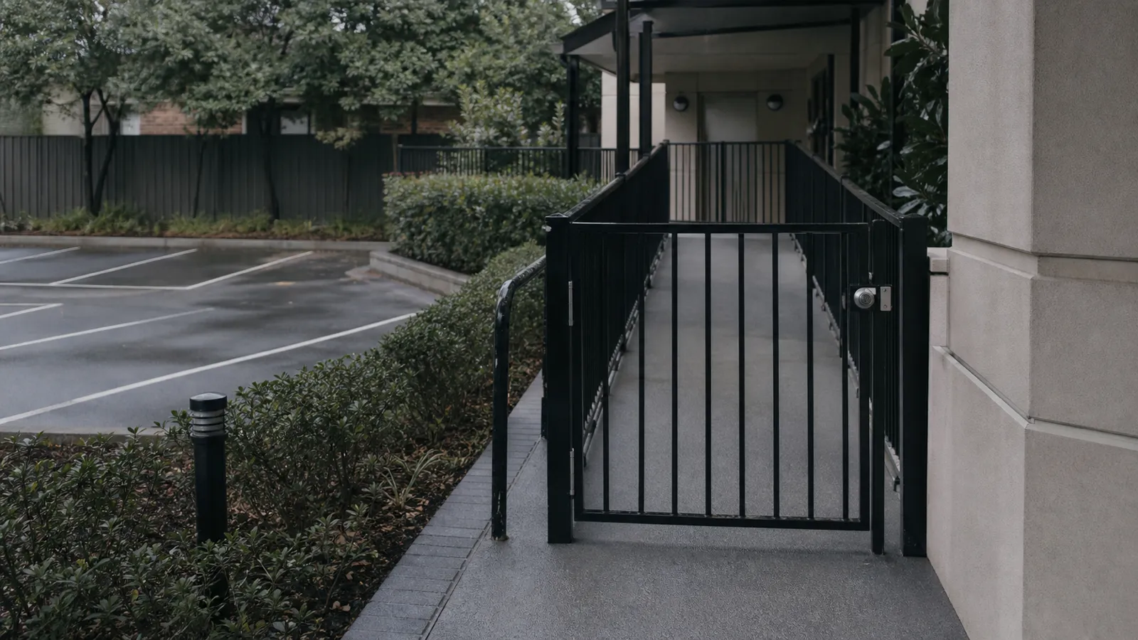 Fenced drop-off zone and self-latching gate on common property at a childcare strata building
