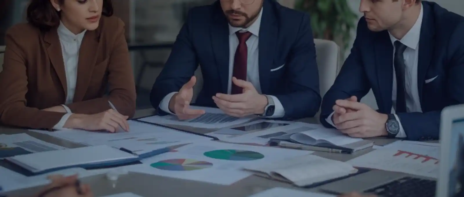 Financial planner presenting investment performance data and portfolio analytics to corporate clients in modern boardroom