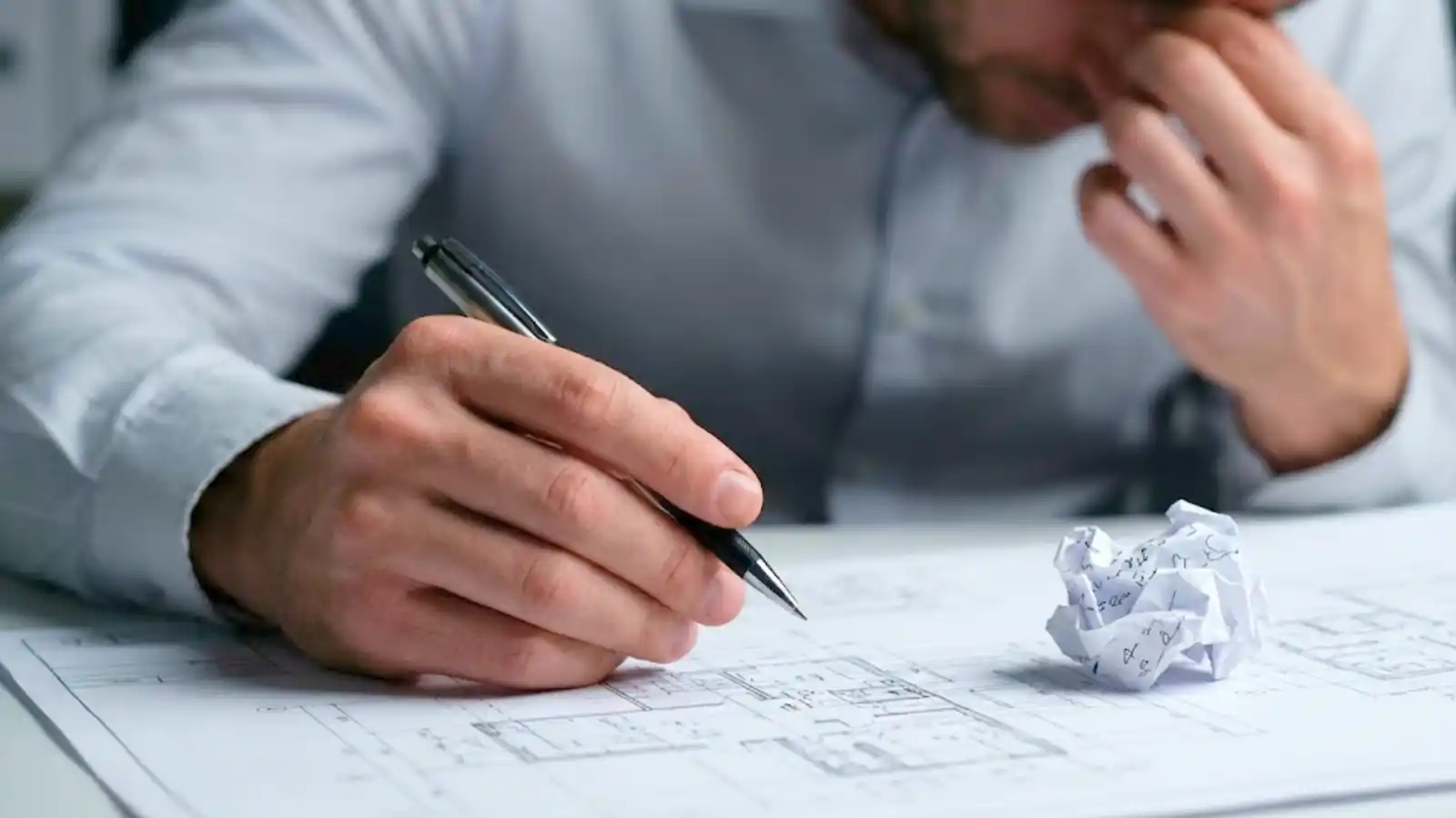 Professional under pressure reviewing documents, highlighting the need for Professional Indemnity insurance