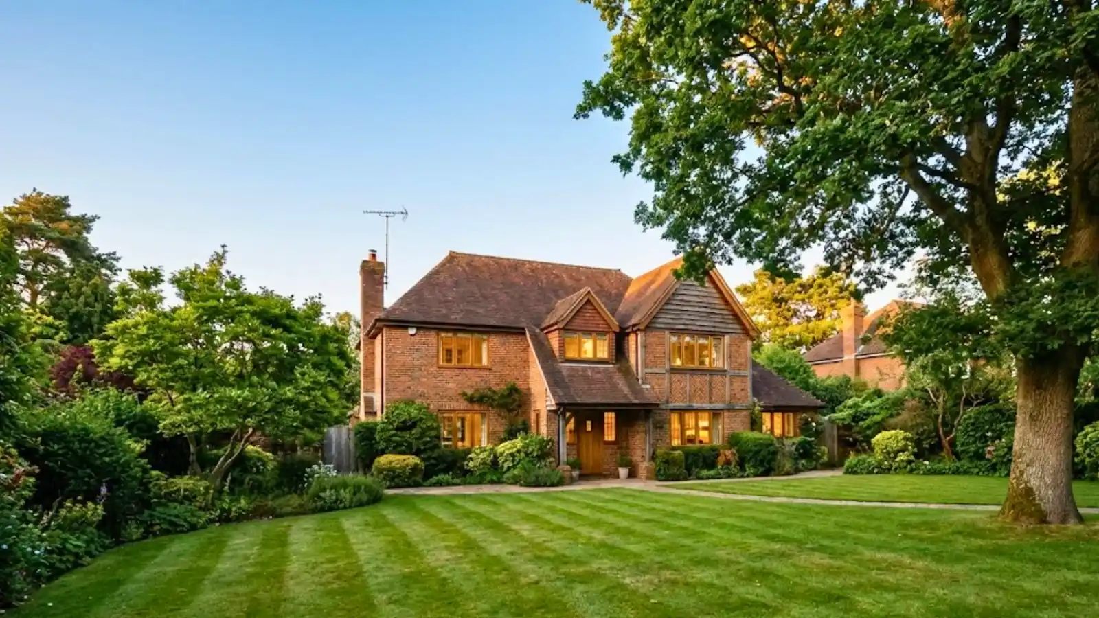 Two-storey Tudor style brick house representing high-value residential property for home insurance brokerage.