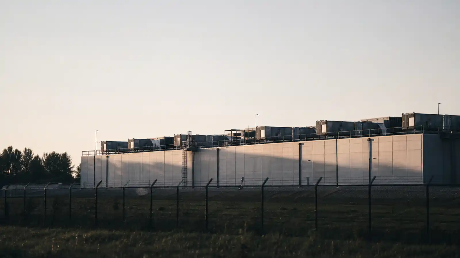 Data centre facility exterior at dawn, the critical infrastructure ISR insurance for data centres protects