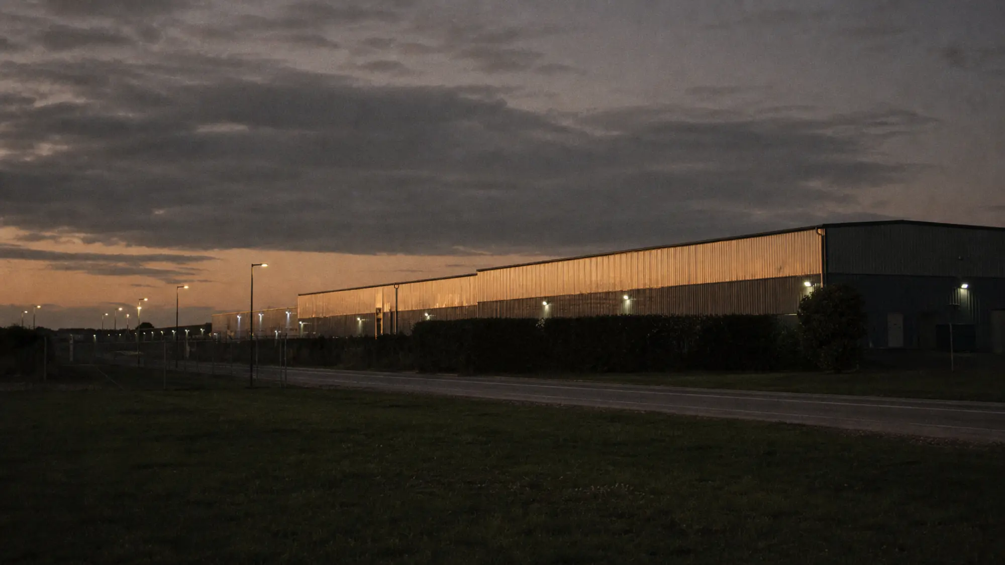 Logistics estate warehouses at dusk, distribution facilities suited to ISR insurance