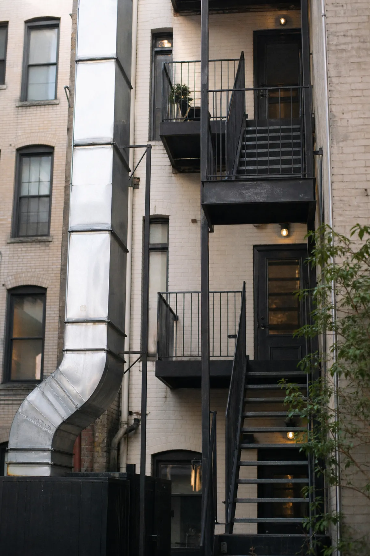 Rear stair and kitchen exhaust on a mixed-use building, shared services under ISR cover