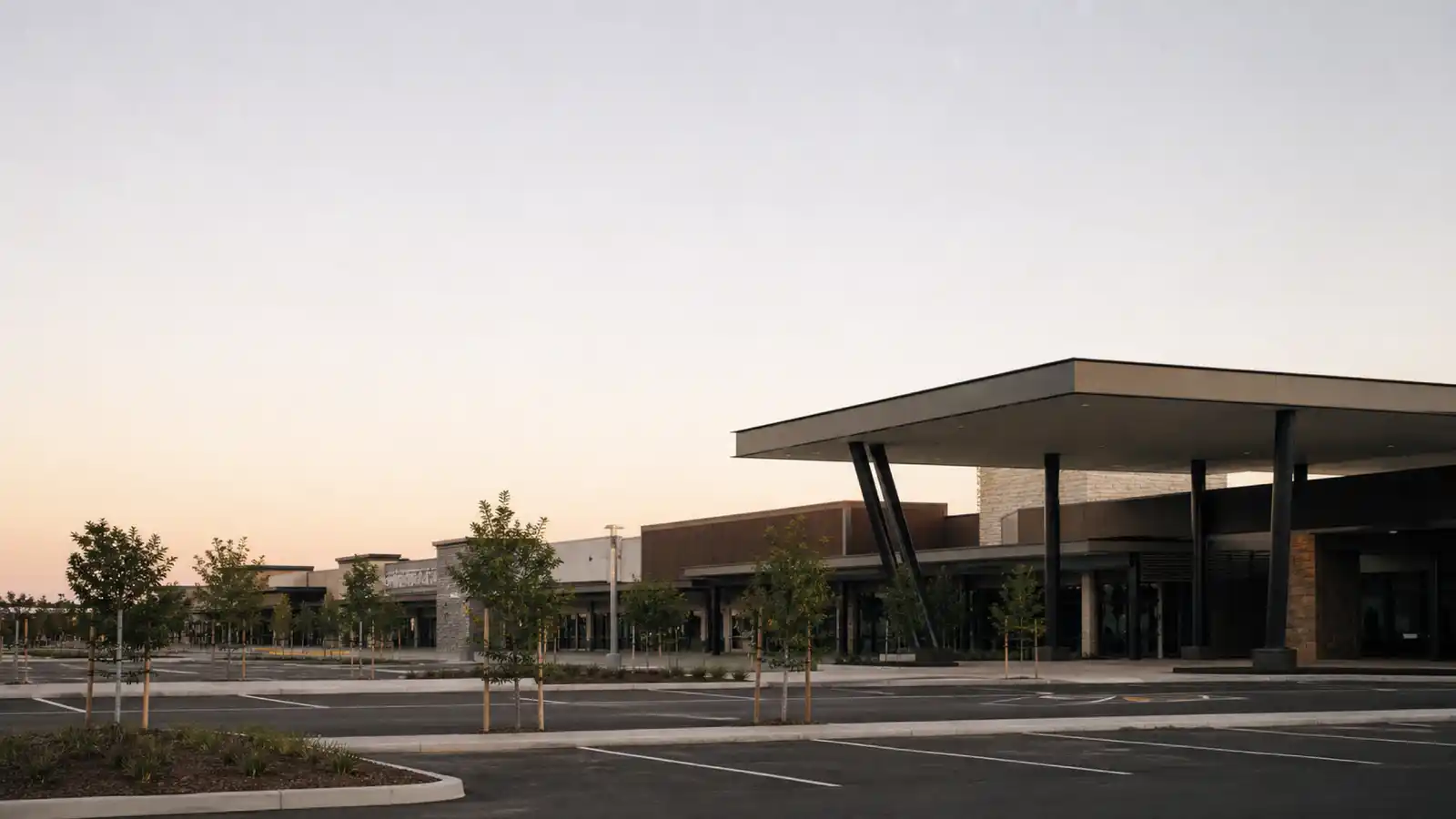 Suburban shopping centre and car park at dawn, retail complex insured under ISR insurance