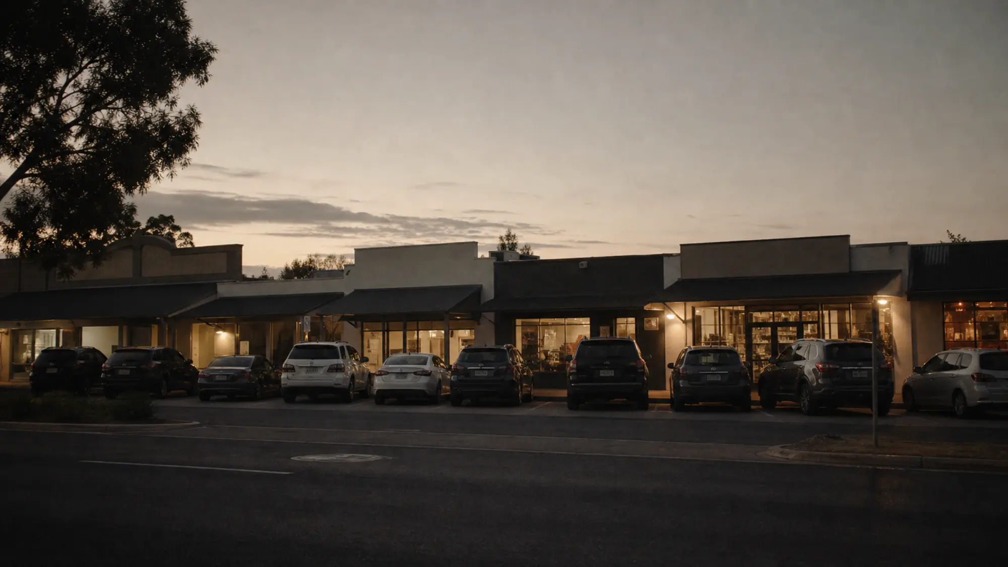 Retail strip shopfronts at dusk, multi-tenancy retail property suited to ISR cover