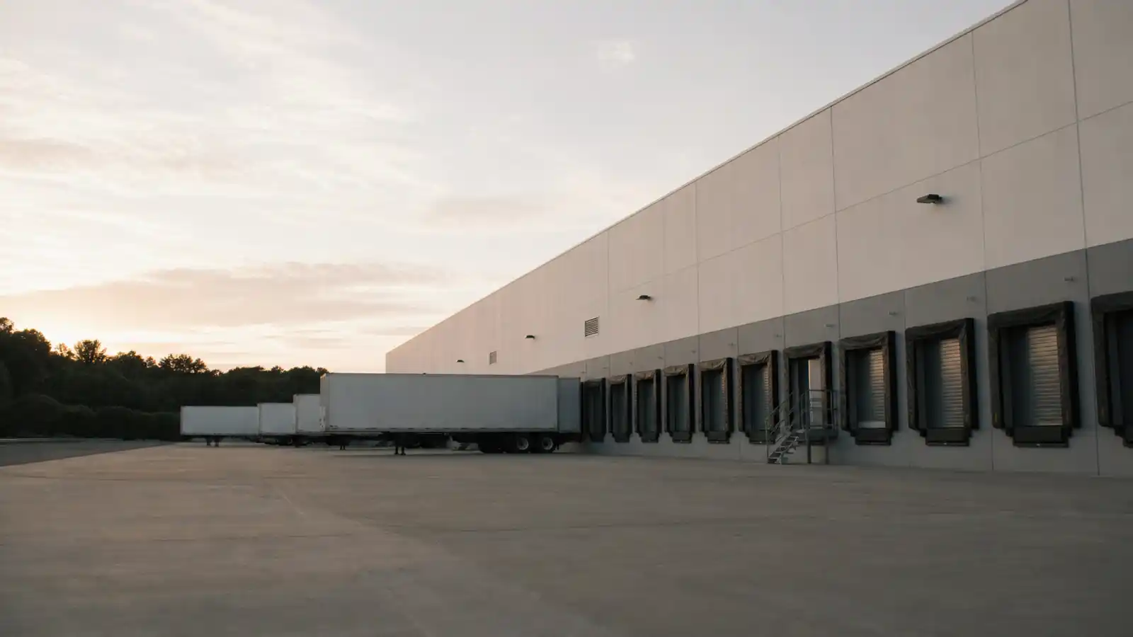 Distribution centre loading docks at dawn, logistics facility covered by ISR insurance for warehouses