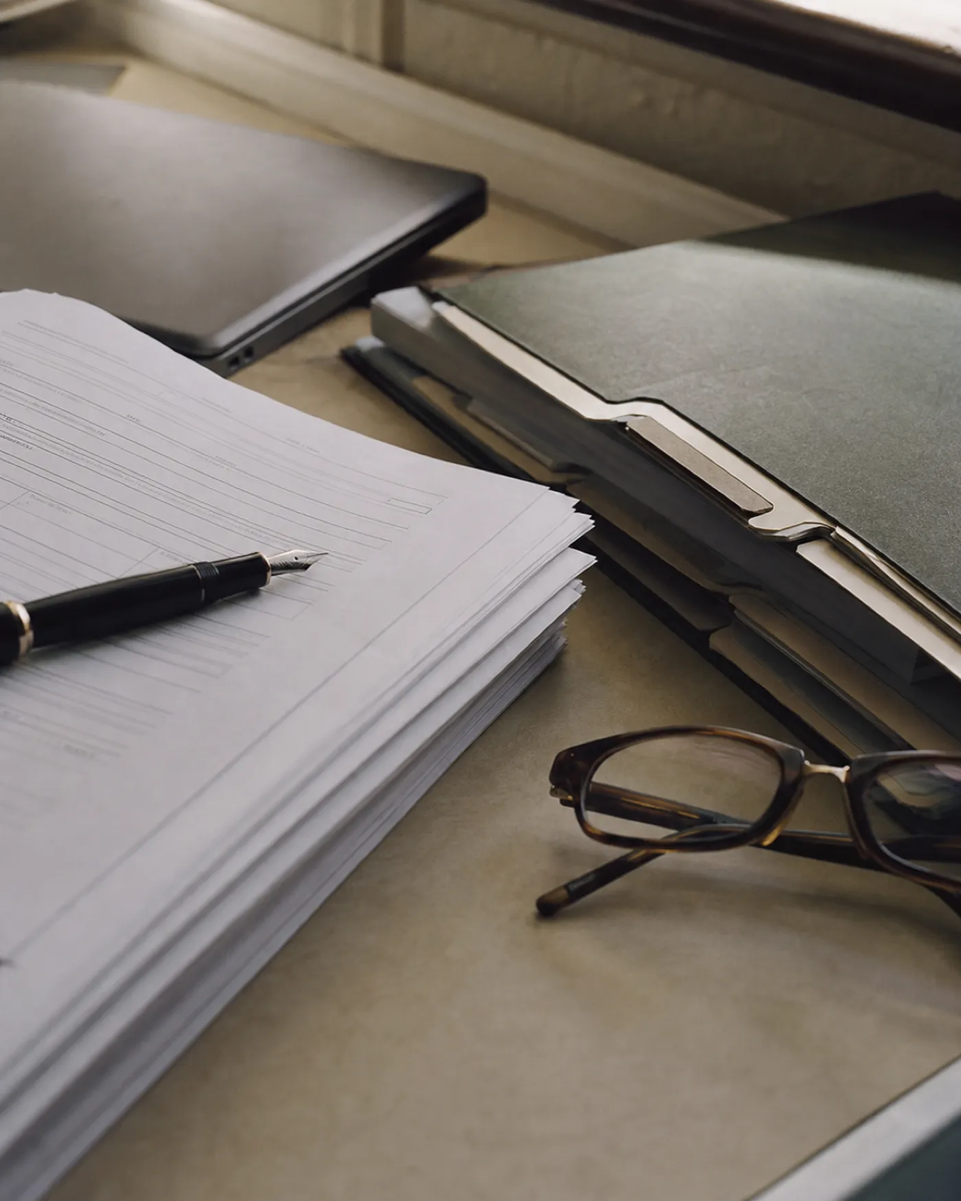 Insurance submission paperwork on a broker's desk for a life sciences placement