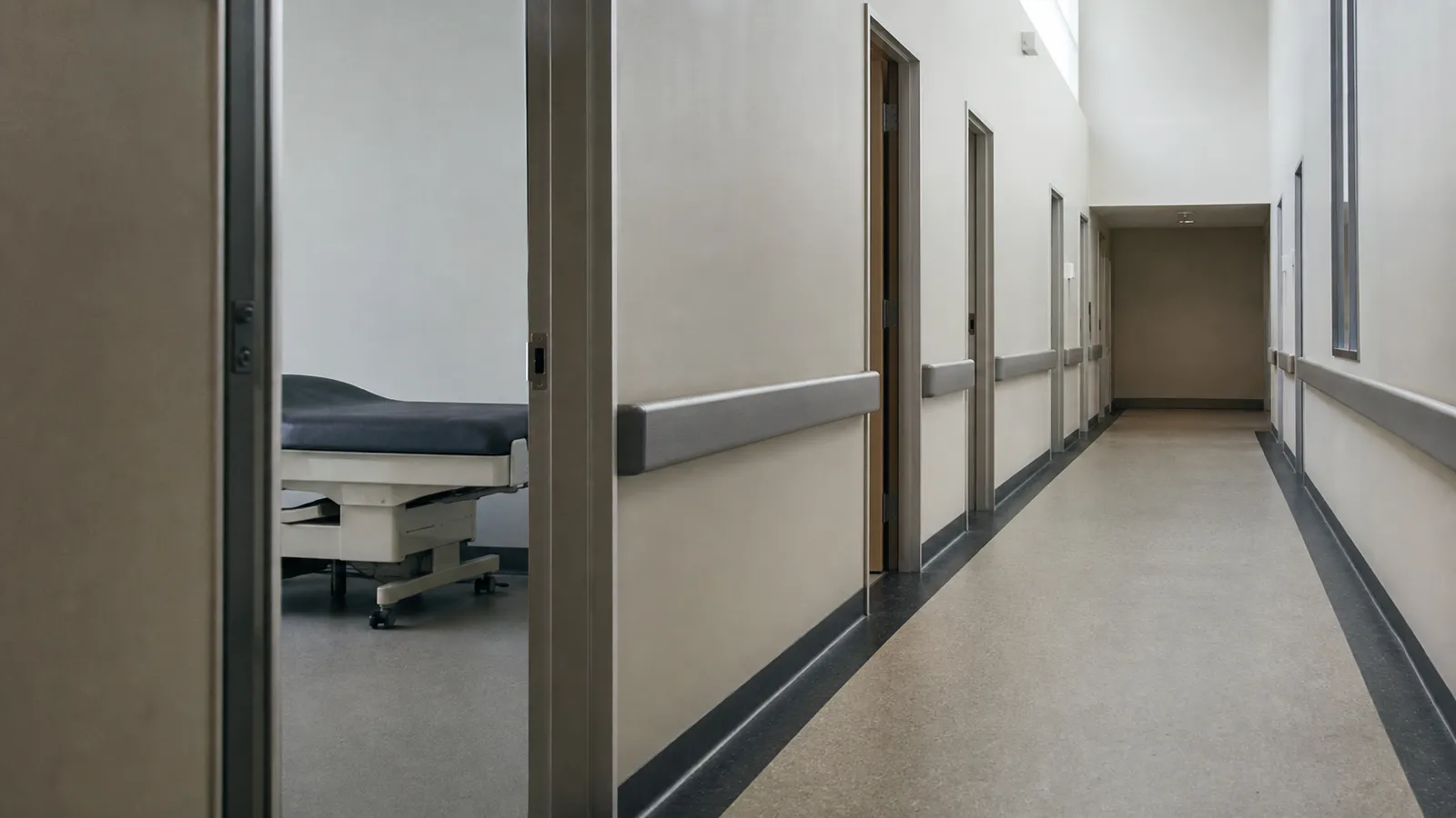 Shared corridor with handrails in a medical centre strata building's common property