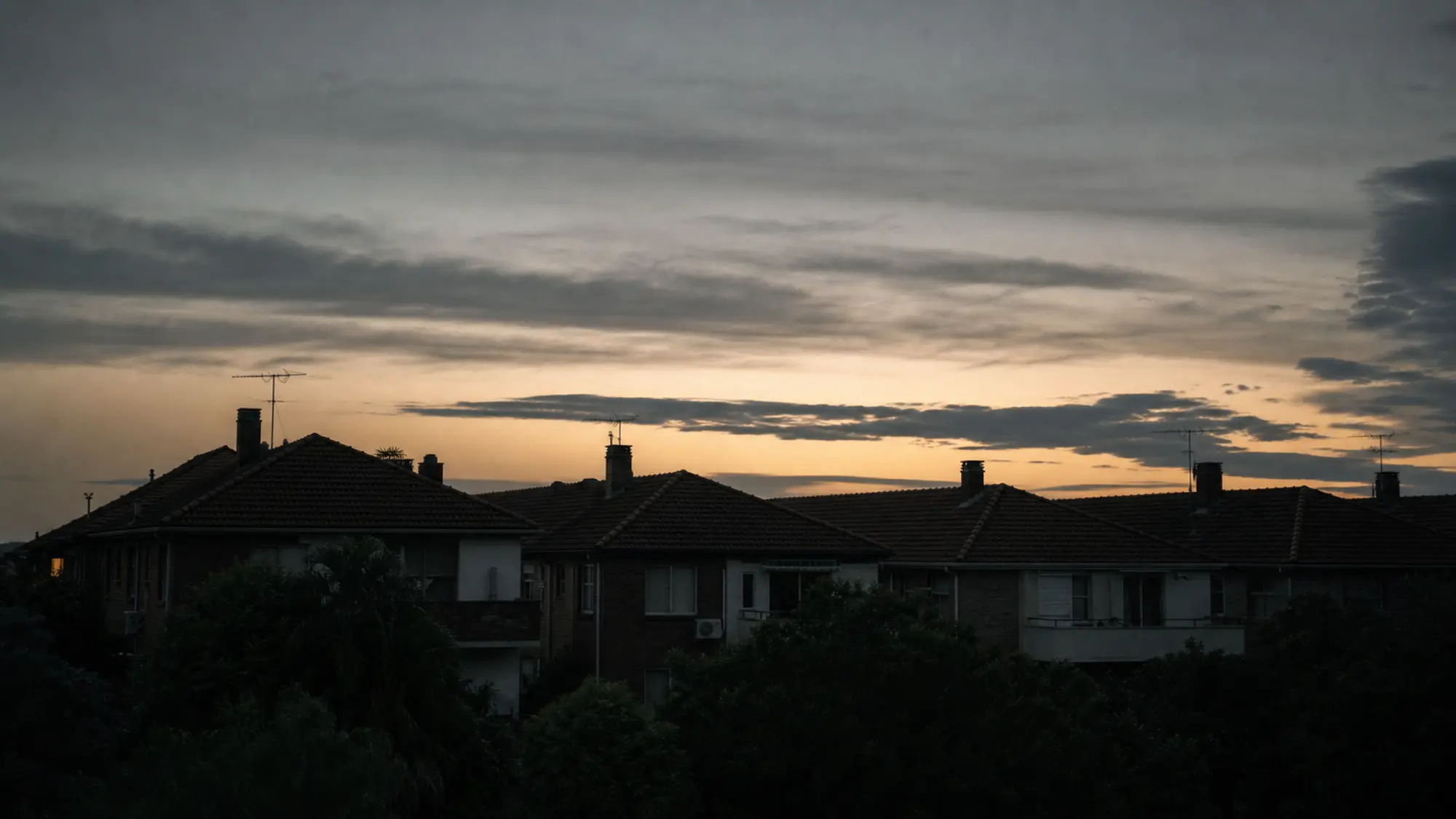 Multi-unit residential rooftops at dusk for multi dwelling insurance