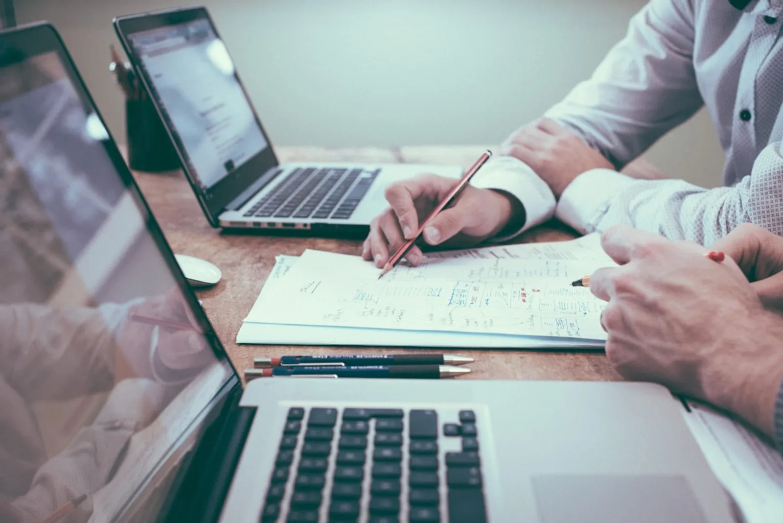 Bookkeeper working at a desk with laptop and financial documents