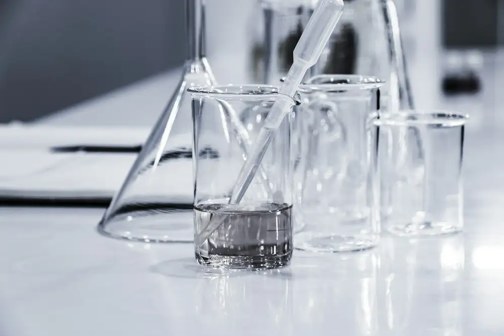 Laboratory glassware including beakers and flasks used in pharmaceutical and chemical research.