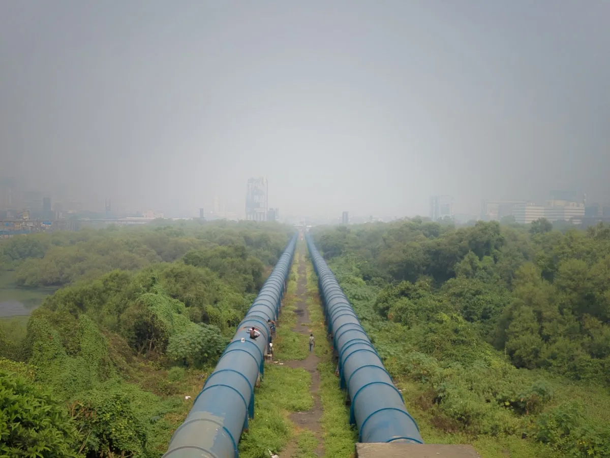 Twin water supply pipelines running through landscape representing water infrastructure engineering