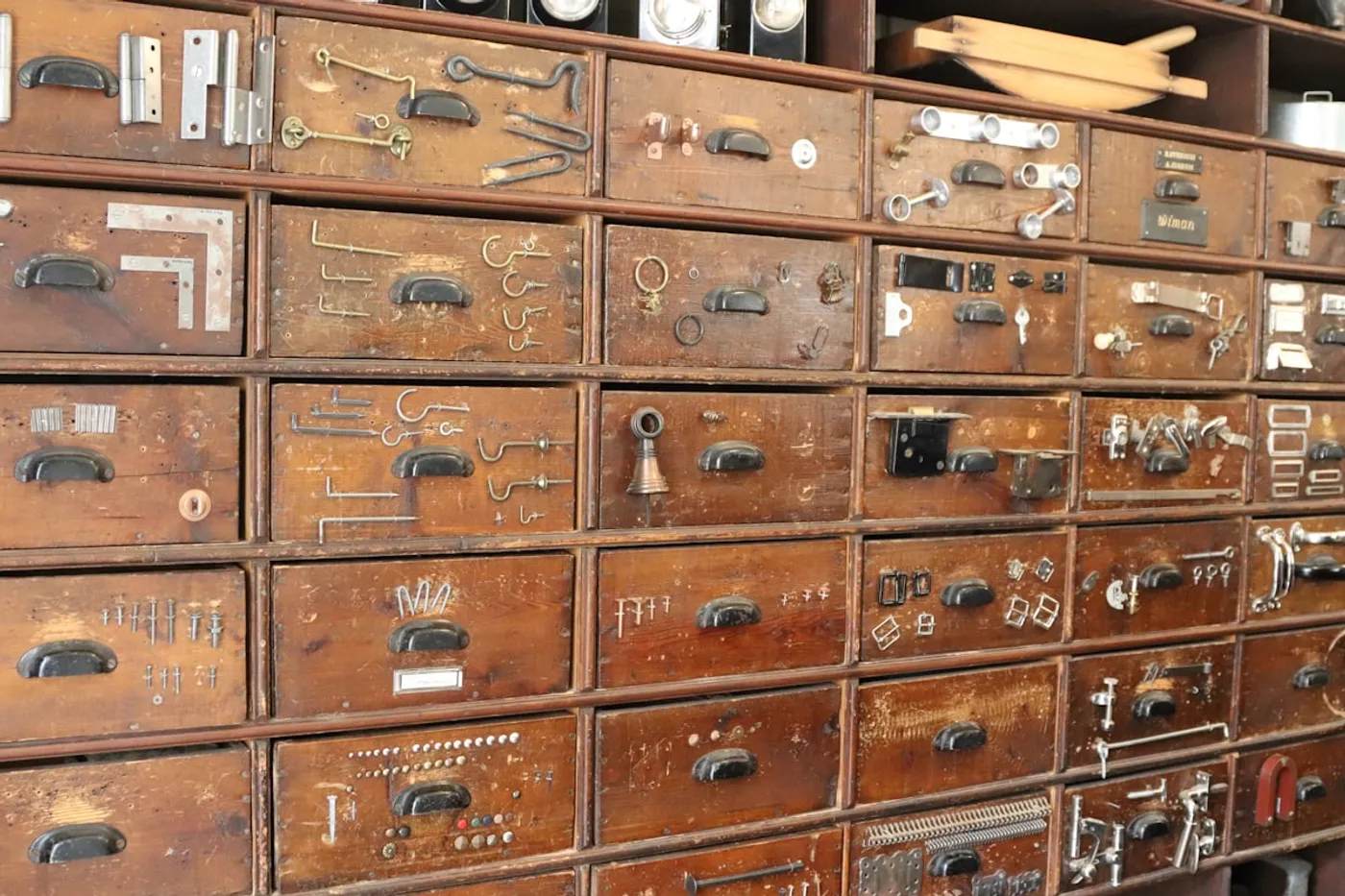 Antique drawers and hardware items on display at an auction house