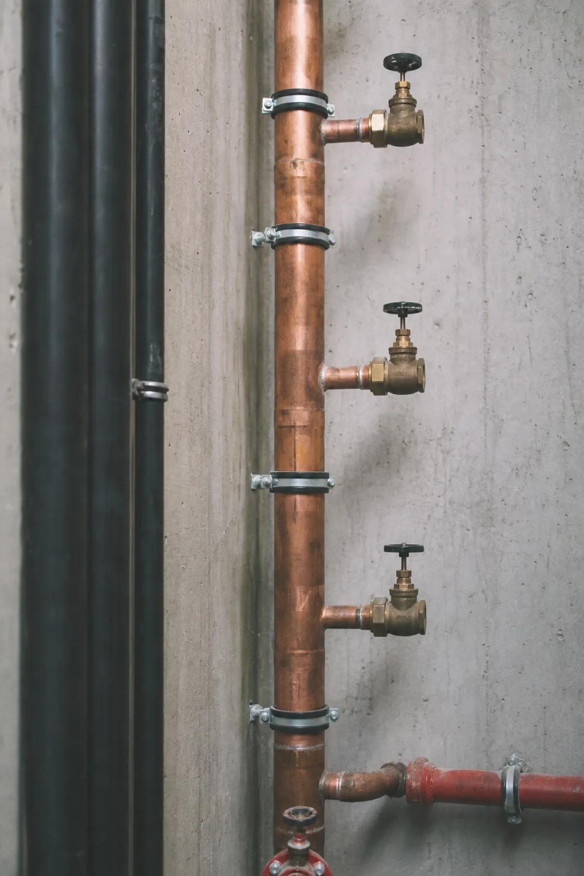 Copper riser and isolation valves in a service shaft - plumbing engineer PI insurance