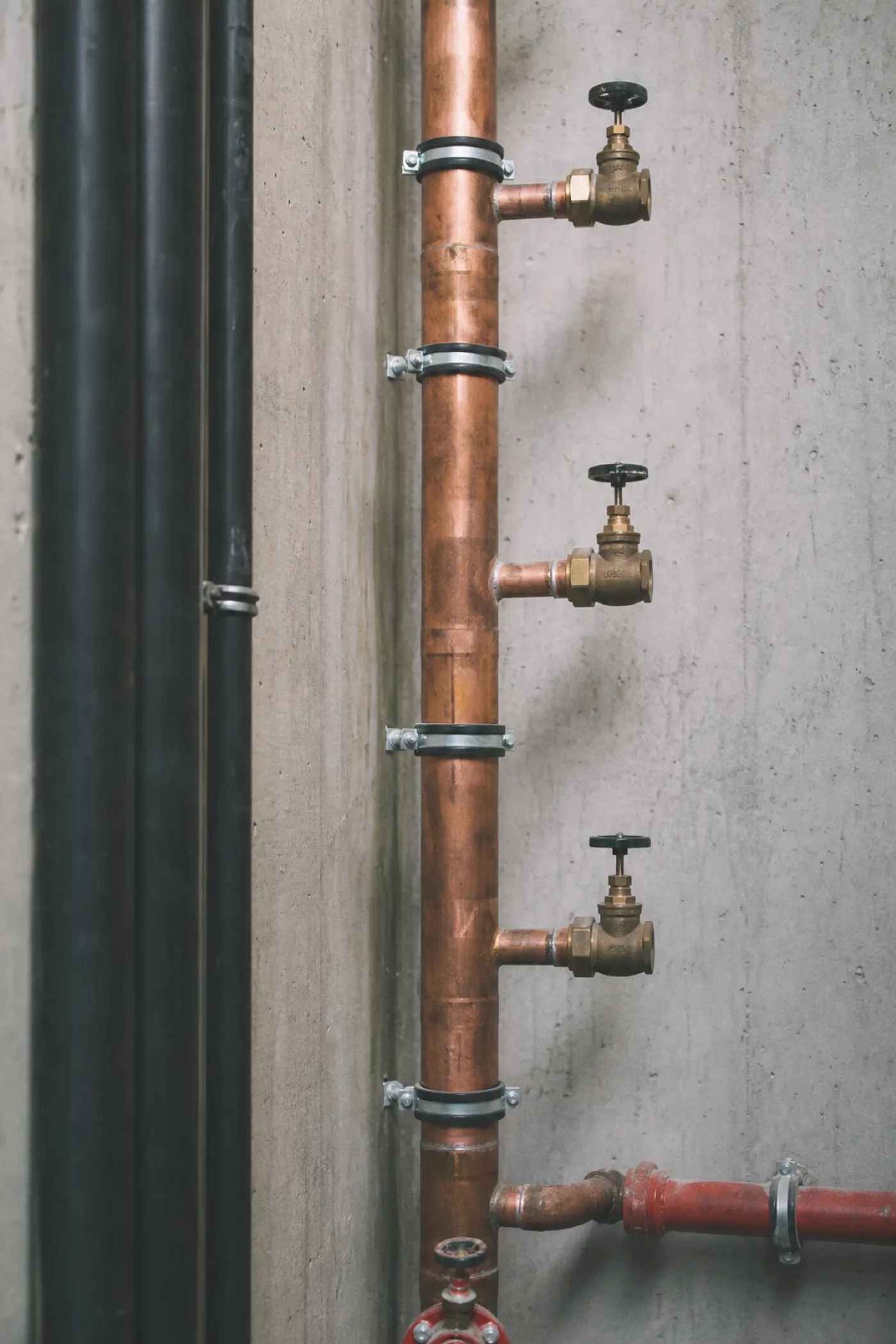 Copper riser and isolation valves in a service shaft - plumbing engineer PI insurance