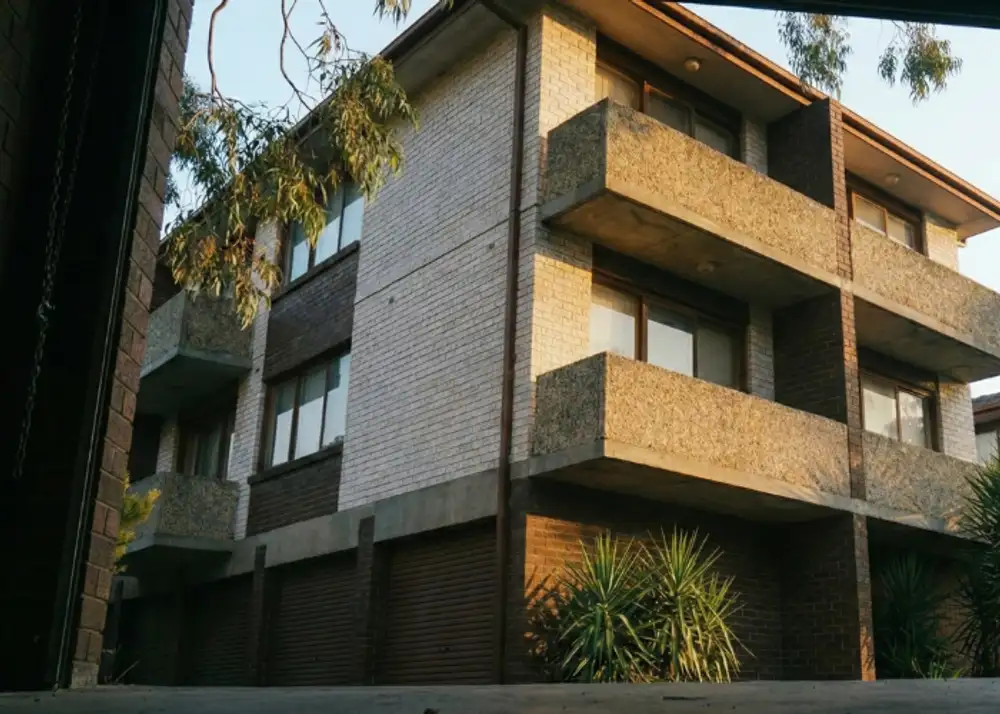 View of common area driveways and balconies in a block of units, highlighting the need for public liability coverage.