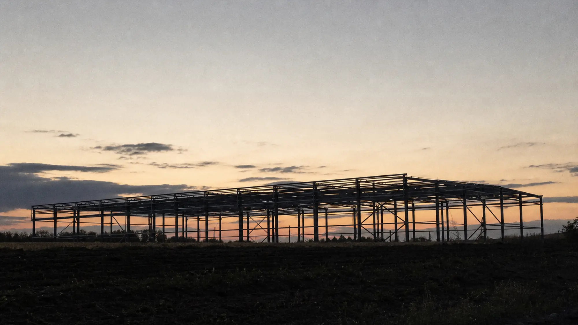 Steel frame at dusk - structural engineer insurance quote