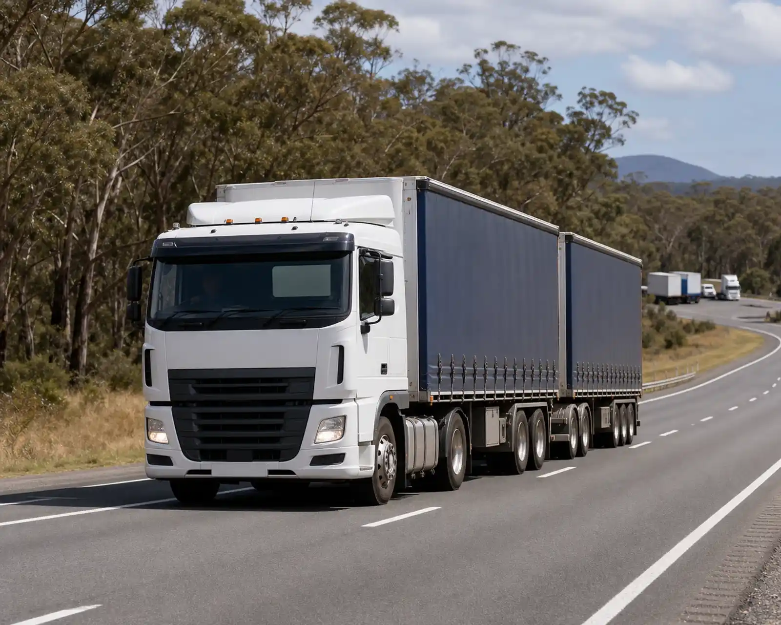Australian heavy vehicle travelling on a highway through eucalyptus bushland